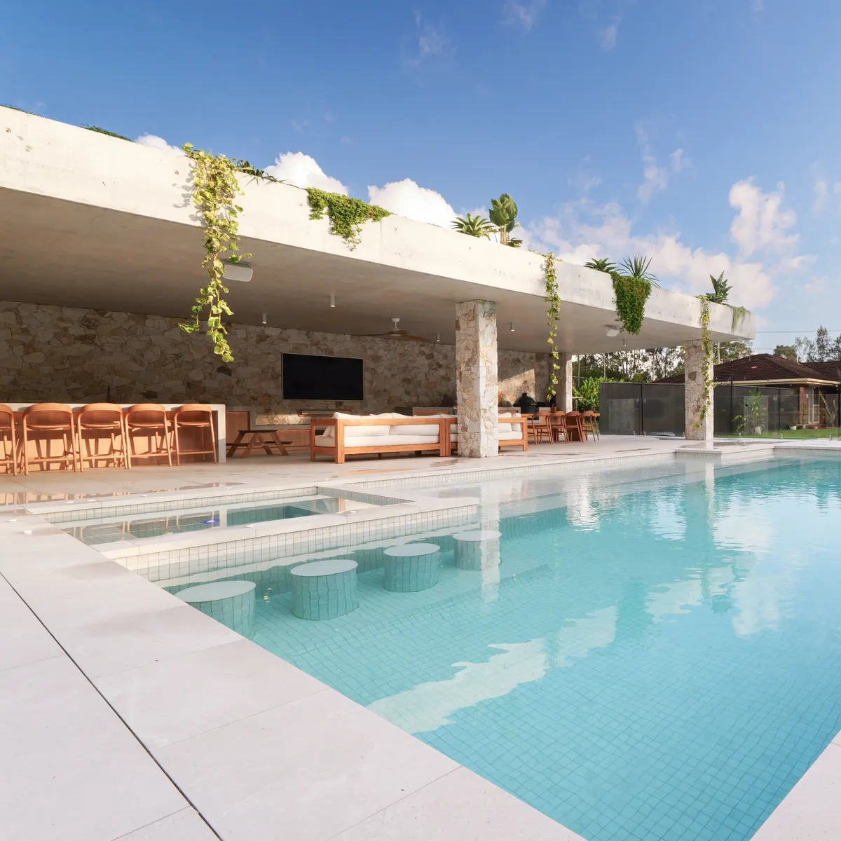 Tiled concrete pool and spa with stone-clad outdoor entertaining area, Currumbin