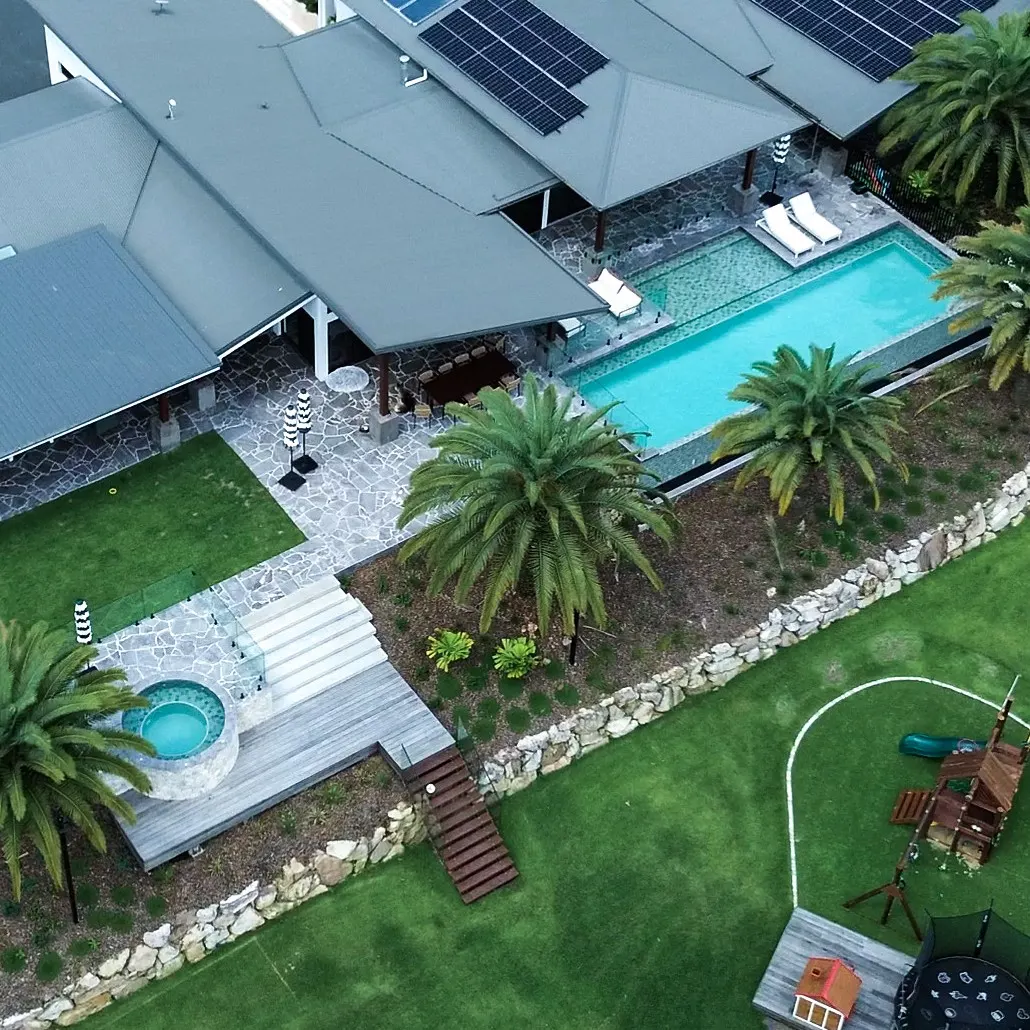 Aerial view of concrete pool and spa surrounded by tropical landscaping, Currumbin Valley